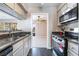 Bright kitchen with granite countertops and stainless steel appliances, seamlessly flowing into the living area at 778 Oakmont Ave # 312, Las Vegas, NV 89109