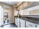 Modern kitchen featuring stainless steel appliances, granite countertops, and black tile flooring at 778 Oakmont Ave # 312, Las Vegas, NV 89109