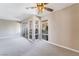 Neutral living area featuring natural light from windows, carpet, and a ceiling fan at 778 Oakmont Ave # 312, Las Vegas, NV 89109