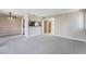 Neutral, bright living area with updated light fixture, carpet, bar looking into the kitchen and bathroom entryway at 778 Oakmont Ave # 312, Las Vegas, NV 89109