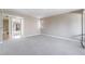 Neutral living area featuring neutral walls, carpet, and entryways to the bathroom and kitchen at 778 Oakmont Ave # 312, Las Vegas, NV 89109