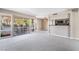Spacious living room featuring plush carpeting, a bar area, and sliding glass doors leading to a lovely outdoor patio at 778 Oakmont Ave # 312, Las Vegas, NV 89109