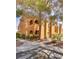 Beautiful condo building featuring desert landscaping and mature shade trees at 7950 W Flamingo Rd # 2065, Las Vegas, NV 89147