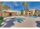 Inviting community pool with a separate hot tub, surrounded by lounge chairs and lush greenery at 7950 W Flamingo Rd # 2065, Las Vegas, NV 89147