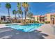 Relaxing community pool surrounded by palm trees, lounge chairs, and lush greenery at 7950 W Flamingo Rd # 2065, Las Vegas, NV 89147