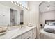 Bright bathroom with white marble-look countertop and large mirror, offering modern amenities and a clean, elegant aesthetic at 801 Aquitaine Ct, Las Vegas, NV 89145