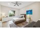 Bright bedroom featuring a ceiling fan, window view, and stylish decor for a comfortable, modern living space at 801 Aquitaine Ct, Las Vegas, NV 89145