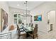 Stylish dining room with a glass table, comfortable seating, and a window offering scenic outdoor views at 801 Aquitaine Ct, Las Vegas, NV 89145