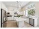Well-lit kitchen features stainless steel appliances, an island, and ample counter space at 801 Aquitaine Ct, Las Vegas, NV 89145