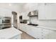 Well-equipped kitchen with stainless steel appliances, sleek white cabinetry, and spacious countertops at 801 Aquitaine Ct, Las Vegas, NV 89145