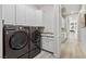 Well-equipped laundry room with modern washer and dryer, ample counter space and storage cabinets at 801 Aquitaine Ct, Las Vegas, NV 89145