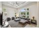 Bright living room features large windows, a ceiling fan, and an open concept floor plan at 801 Aquitaine Ct, Las Vegas, NV 89145