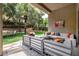 Relaxing covered patio with plush seating, heaters, and views of the landscaped backyard at 801 Aquitaine Ct, Las Vegas, NV 89145
