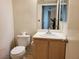 Cozy bathroom with a single sink vanity, toilet, and a mirrored cabinet for storage at 8070 W Russell Rd # 1028, Las Vegas, NV 89113
