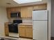 Functional kitchen with wood cabinets, practical appliances, and plenty of counter space for meal prep at 8070 W Russell Rd # 1028, Las Vegas, NV 89113