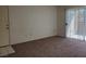 Inviting living room with plush carpet and a sliding glass door that provides outdoor access at 8070 W Russell Rd # 1028, Las Vegas, NV 89113