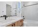 Bright bathroom featuring modern fixtures, a large mirror, and tiled walls, creating a spa-like ambiance at 8721 Robinson Ridge Dr, Las Vegas, NV 89117