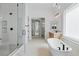 Bright bathroom with a glass enclosed shower, free standing tub, modern fixtures, and natural light at 8721 Robinson Ridge Dr, Las Vegas, NV 89117