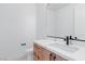 Modern bathroom featuring a sleek marble countertop, wood cabinets, and contemporary fixtures at 8721 Robinson Ridge Dr, Las Vegas, NV 89117