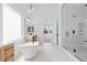 Bright bathroom with a glass enclosed shower, free standing tub, modern fixtures and beautiful tile at 8721 Robinson Ridge Dr, Las Vegas, NV 89117