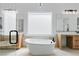 Primary bath features dual sinks, a free standing tub and a large window for natural light at 8721 Robinson Ridge Dr, Las Vegas, NV 89117
