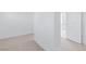 Bright bedroom with carpet flooring and an open doorway leading to a bathroom at 8721 Robinson Ridge Dr, Las Vegas, NV 89117