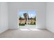 Bright bedroom with neutral carpet and a sliding glass door leading to an outdoor space at 8721 Robinson Ridge Dr, Las Vegas, NV 89117