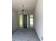 Modern entryway with a sleek black door, contemporary light fixture, and stylish gray tile flooring at 8721 Robinson Ridge Dr, Las Vegas, NV 89117