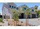 View of the side of a two-story home featuring stone accents, a three-car garage, and desert landscaping at 8721 Robinson Ridge Dr, Las Vegas, NV 89117
