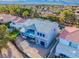 Rear view of the modern new construction home featuring a second-story patio with blue glass panels at 8721 Robinson Ridge Dr, Las Vegas, NV 89117