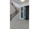 Bright foyer with a modern front door, staircase with wood handrail, and tile flooring at 8721 Robinson Ridge Dr, Las Vegas, NV 89117