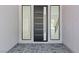 An elegant foyer featuring modern front door with sidelights and tile flooring at 8721 Robinson Ridge Dr, Las Vegas, NV 89117