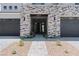 Beautiful entrance with stone accents and a modern black front door at 8721 Robinson Ridge Dr, Las Vegas, NV 89117