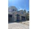 Three-car garage with sleek gray doors and a brick-paved driveway offers ample parking and curb appeal at 8721 Robinson Ridge Dr, Las Vegas, NV 89117