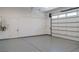Bright garage featuring epoxy flooring, an insulated door, and a tankless water heater at 8721 Robinson Ridge Dr, Las Vegas, NV 89117