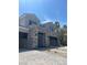 Spacious three-car garage with a sleek gray door and brick-paved driveway, perfect for car enthusiasts at 8721 Robinson Ridge Dr, Las Vegas, NV 89117