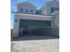 Large three-car garage featuring a sleek, modern door and spacious interior with brick paved driveway at 8721 Robinson Ridge Dr, Las Vegas, NV 89117