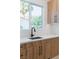 Bright and modern kitchen with wood cabinets, black hardware, and an open window view at 8721 Robinson Ridge Dr, Las Vegas, NV 89117