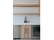 Kitchen features a wet bar with wood cabinets, wine fridge, sink, and open shelving at 8721 Robinson Ridge Dr, Las Vegas, NV 89117