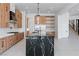 Modern kitchen with large island, wood cabinets, and stainless steel appliances at 8721 Robinson Ridge Dr, Las Vegas, NV 89117