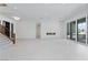 Spacious open-concept living room features tile floors, fireplace, and access to outdoor kitchen at 8721 Robinson Ridge Dr, Las Vegas, NV 89117