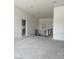 Open living area with modern staircase and contemporary lighting fixture overhead at 8721 Robinson Ridge Dr, Las Vegas, NV 89117