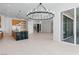 Spacious open floor plan with elegant chandelier and kitchen island at 8721 Robinson Ridge Dr, Las Vegas, NV 89117
