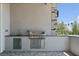Outdoor kitchen with stainless steel grill and stone accents is perfect for entertaining at 8721 Robinson Ridge Dr, Las Vegas, NV 89117