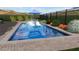 Pool featuring in-pool loungers, brick patio, and landscaping at 8721 Robinson Ridge Dr, Las Vegas, NV 89117