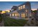 Two-story home with a balcony, stone accents, large sliding glass doors, and well-manicured lawn at 8721 Robinson Ridge Dr, Las Vegas, NV 89117
