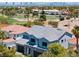 Two-story home featuring stone accents, a three-car garage, and a view of the Las Vegas skyline at 8721 Robinson Ridge Dr, Las Vegas, NV 89117