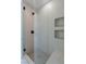 Modern walk-in shower featuring neutral tile and dual built-in shower storage at 8721 Robinson Ridge Dr, Las Vegas, NV 89117