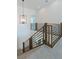 Bright foyer with modern metal-railed staircase illuminated by a stylish chandelier at 8721 Robinson Ridge Dr, Las Vegas, NV 89117