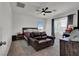 Bright bedroom featuring large windows, ceiling fan, and cozy sitting area at 8870 Sasquatch Run Ave, Las Vegas, NV 89166